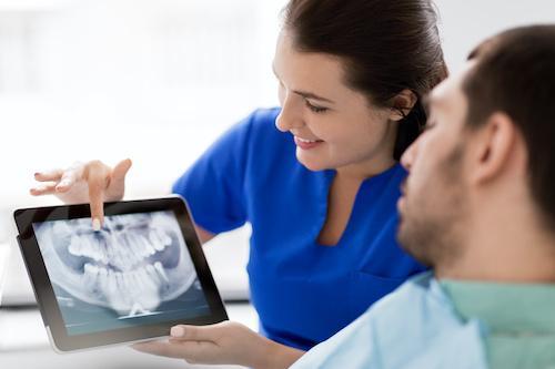 dentist showing patient a digital xray