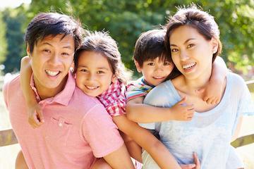 family of four smiling