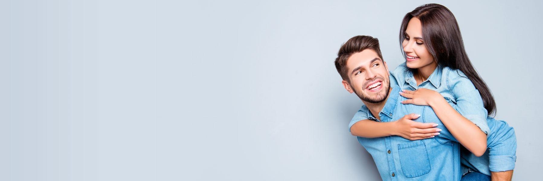 Young couple hugging & smiling l Dentist Alpharetta