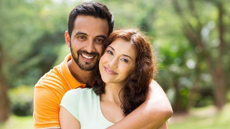 A couple smiling after cosmetic dentistry in Alpharetta Creek Restorative Dentistry