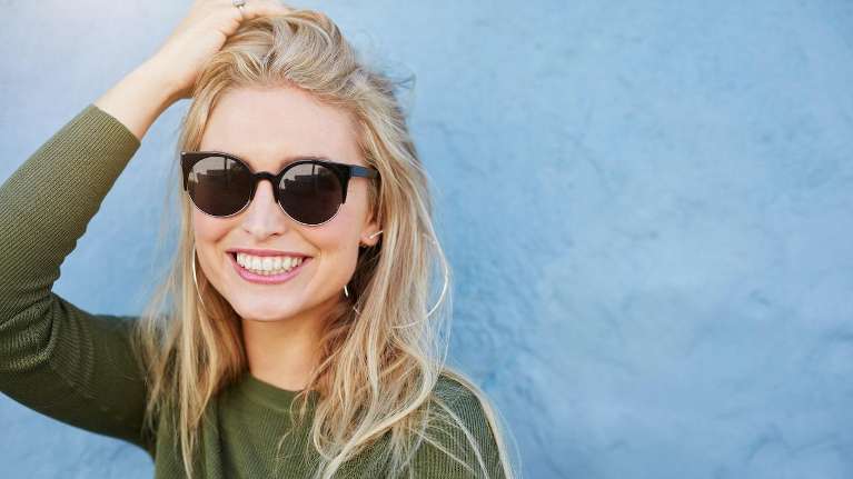 A female smiling after getting a Teeth Whitening from Alpharetta Dentists