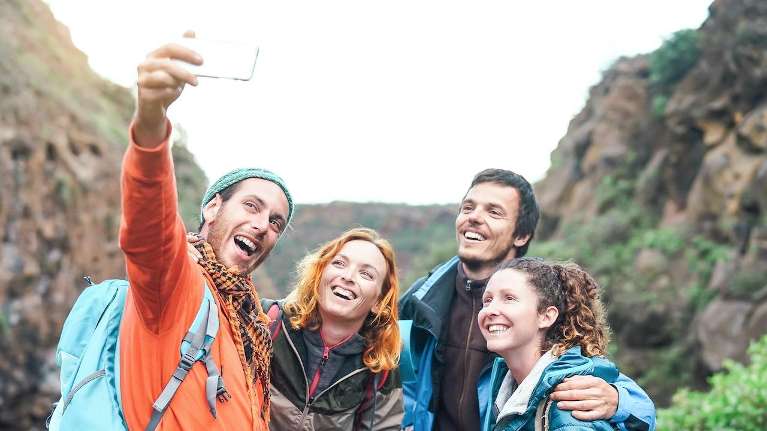 four friends taking a selfie while hiking in alpharetta