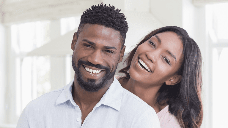 A picture of a couple smiling after tooth-colored fillings in Alpharetta Creek Restorative Dentistry