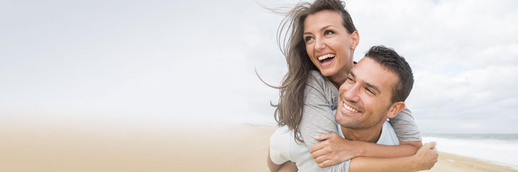 Young couple smiling & hugging in alpharetta