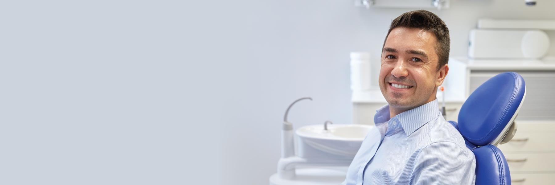 man sitting in dental chair before getting a crown in alpharetta