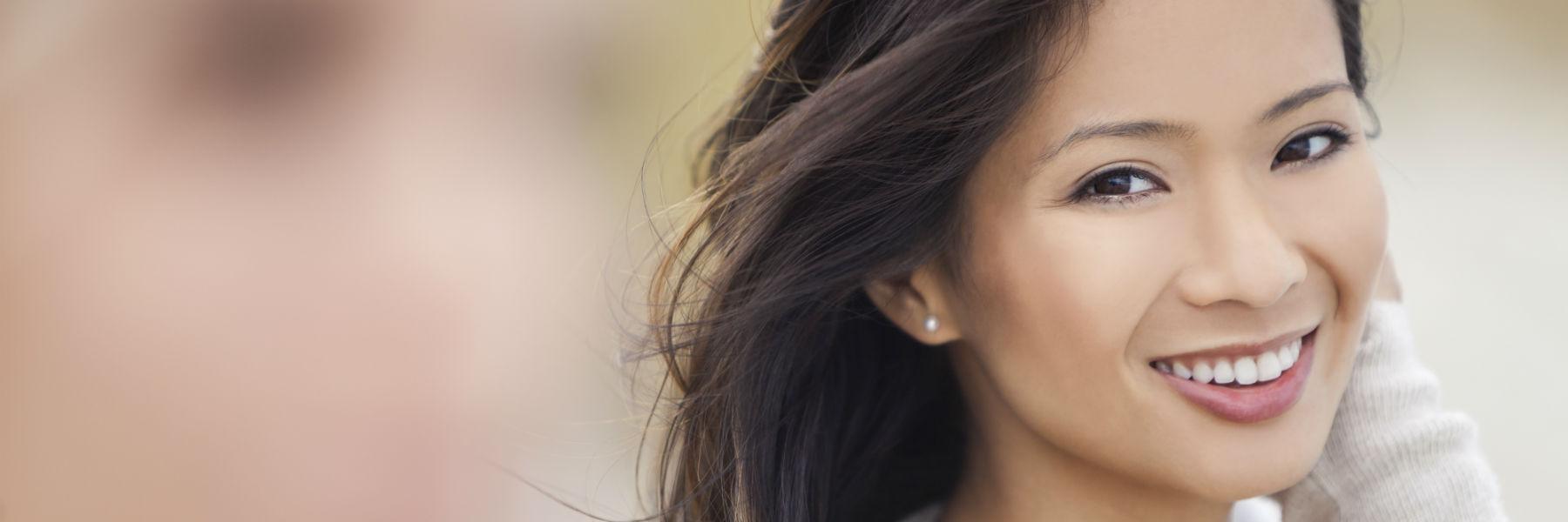woman smiling after getting tooth-colored fillings
